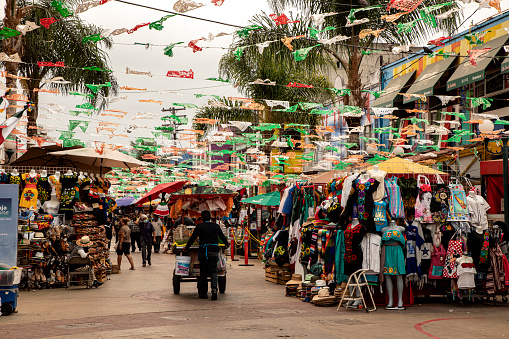 Tijuana, Baja California, Mexico, September 8, 2020. A vendor walks along Santiago Arguello street, which is one of the favorites for tourists and locals to go out at night for a drink and dinner in a Mexican atmosphere.