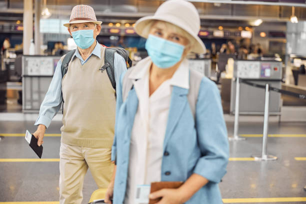 istock Passengers in face masks standing at the airport 1282912893
