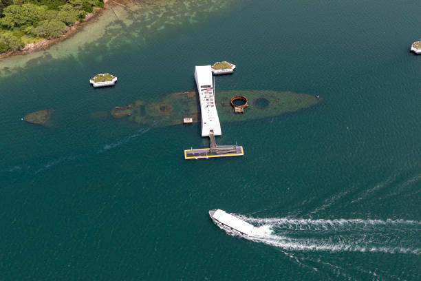 Aerial of USS Arizona at the Pearl Harbor Memorial Aerial of USS Arizona at the Pearl Harbor Memorial during the day. Boat approaches memorial.

Honolulu, Oahu, Hawaii - April 2018 pearl harbor stock pictures, royalty-free photos & images