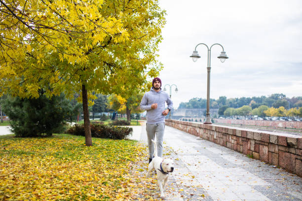istock A young man running with his dog 1282913823