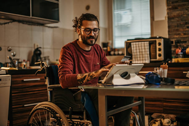 istock man sitting in a wheelchair at home 1282919990