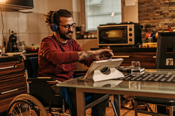 istock man sitting in a wheelchair at home 1282920029
