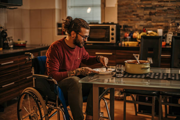istock man sitting in a wheelchair at home 1282920038