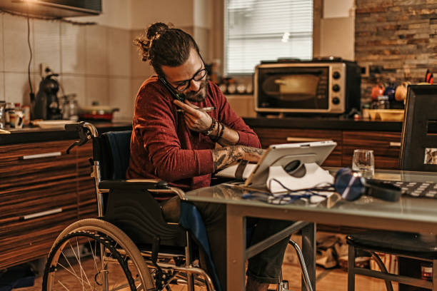 istock man sitting in a wheelchair at home 1282920076