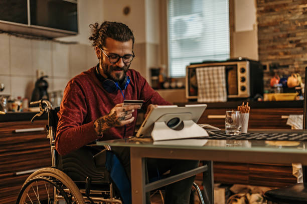 istock man sitting in a wheelchair at home 1282920172
