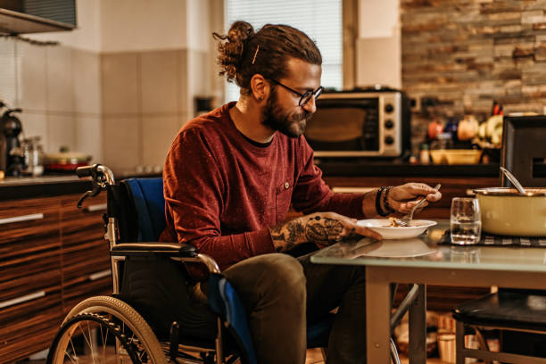 istock man sitting in a wheelchair at home 1282920201