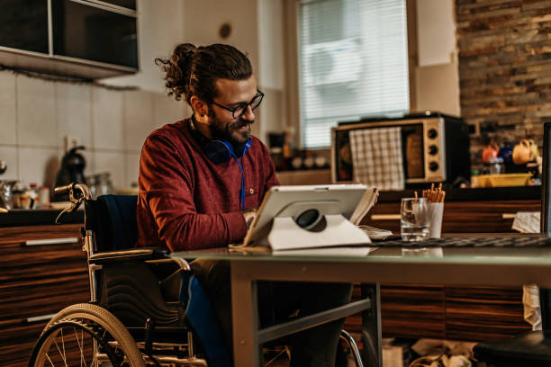 istock man sitting in a wheelchair at home 1282920206