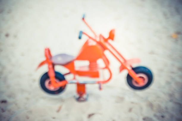 istock Toy motorbike in playground 1282921563