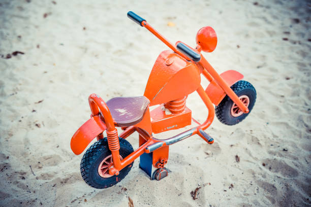 istock Toy motorbike in playground 1282921565
