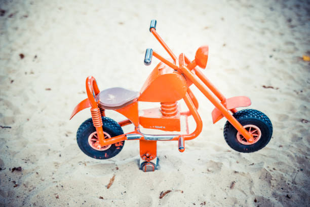 istock Toy motorbike in playground 1282921568