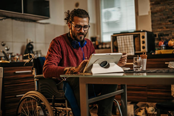 istock man sitting in a wheelchair at home 1282921596