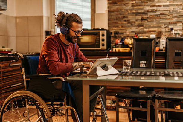 istock man sitting in a wheelchair at home 1282921597