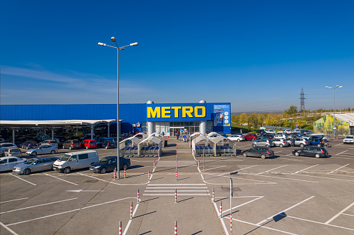 Chisinau, Moldova - October, 2020: Metro retail store, large shopping mall of household and food goods with parking, aerial view, copyspace