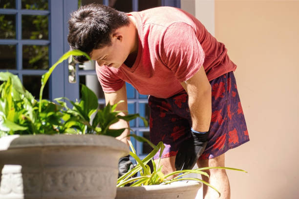 Boy with down syndrome gardening