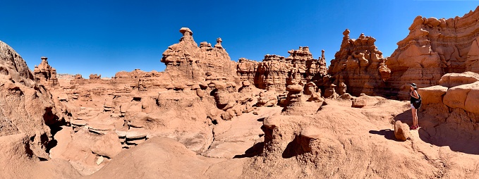 Goblin Valley State Park, Utah, USA - September 4, 2020: Lone female tourist in the park that features thousands of hoodoos, referred to locally as goblins.
