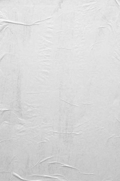 istock Blank white crumpled and creased paper poster texture background 1282928094