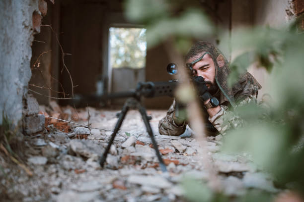 istock Hidden soldier with rifle sniper in building. 1282928268