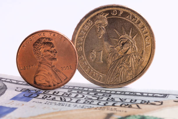 istock One cent coin,one dollar coin, 100 dollars bill 1282929601