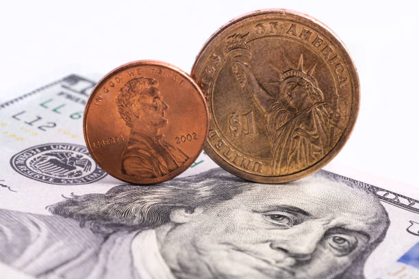 istock One cent coin,one dollar coin, 100 dollars bill 1282929602
