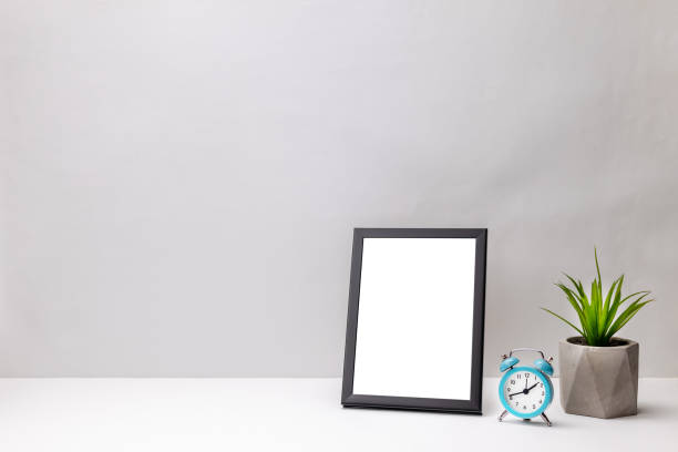 istock blank frame mockup on a white desk. gray wall background. office or home workplace. work planning concept. greeting card template 1282931454