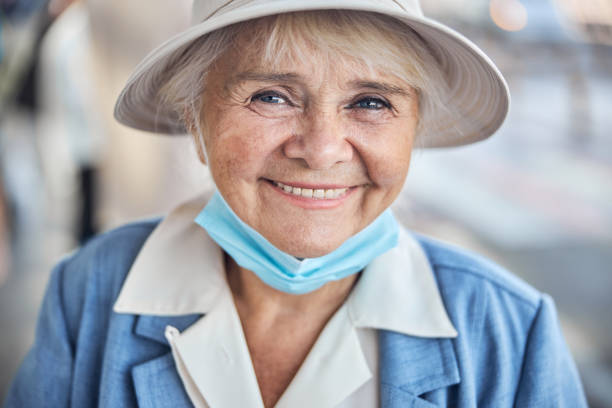 istock Smiling aged woman in a hat posing for the camera 1282932693