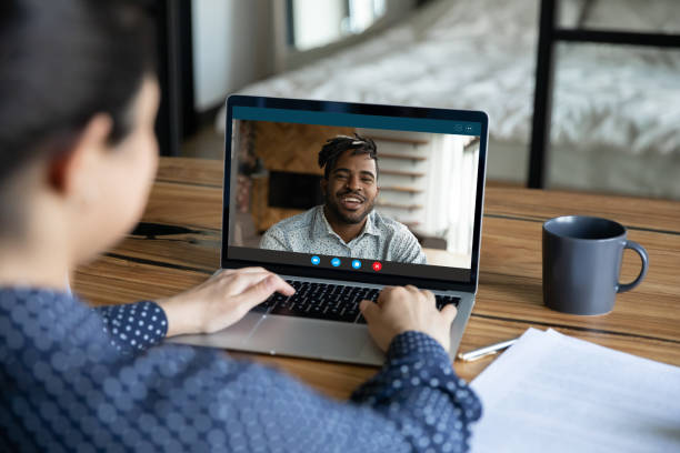 istock Multiethnic colleagues talk on video call on laptop 1282935502