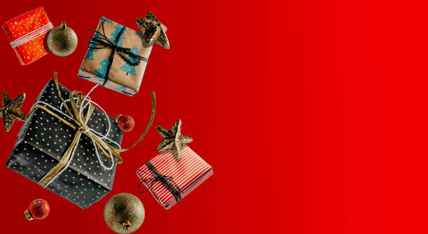 istock White Christmas gift boxes falling or flying in motion on red background. 1282935559