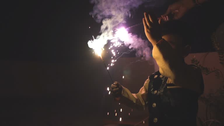 Indian Small boy playing with sparkler crackers on the occasion of Diwali festival celebration. slo mo video.