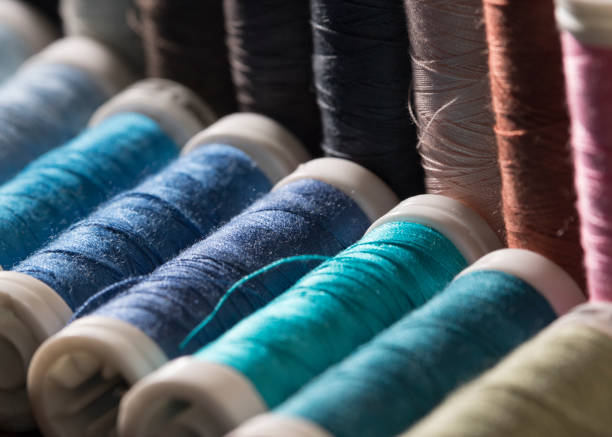 istock Closeup shot of colorful threads on a wooden surface 1282946517