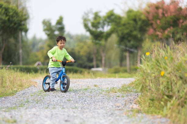 istock A little boy learning to ride a bicycle outdoors 1282949234