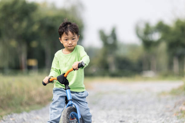 istock A little boy learning to ride a bicycle outdoors 1282949252