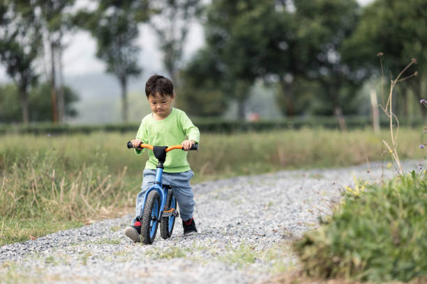 istock A little boy learning to ride a bicycle outdoors 1282949266
