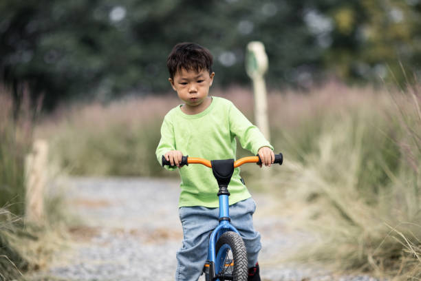 istock A little boy learning to ride a bicycle outdoors 1282949359
