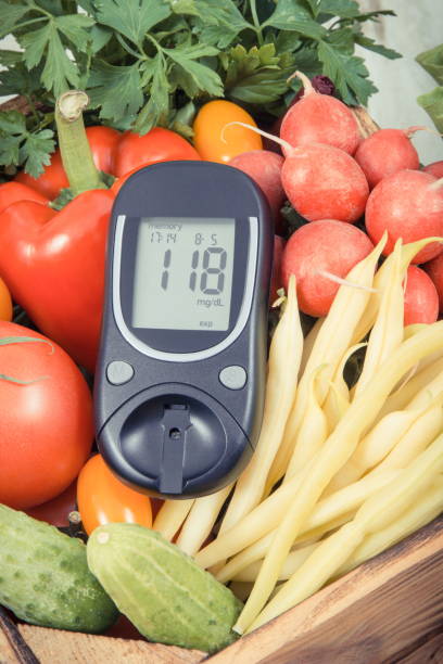 istock Glucometer with fresh vegetables as source minerals and vitamins. Diabetes, healthy lifestyles and dieting 1282950928