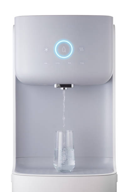 Modern technology concept. New water cooler format. A glass of pouring water. Touch panel with glowing indicator. Technological design. stock photo