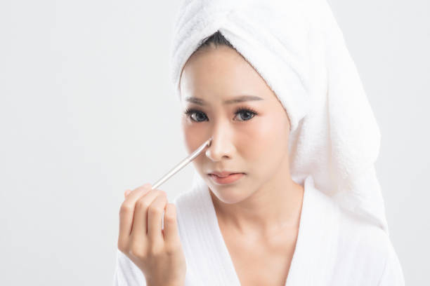 istock Woman in bathrobe with towel with towel on head. 1282953490