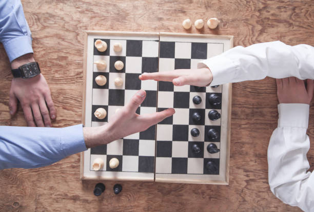 istock Business people shaking hands. Playing chess game 1282954298