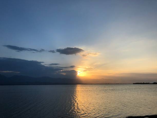 istock Beautiful sunset and evening sky with mountain and clouds at the beach for background. nice view in the north of Thailand. 1282957233