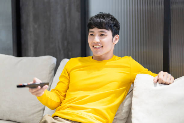 istock man watching tv at home 1282957307