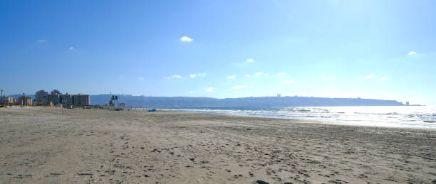istock View on sunny summer beach. Sun, sky, beach Israel. 1282960118