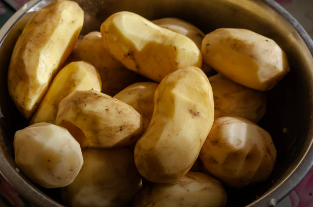 istock Purified raw, unwashed potatoes in  bowl. 1282960167