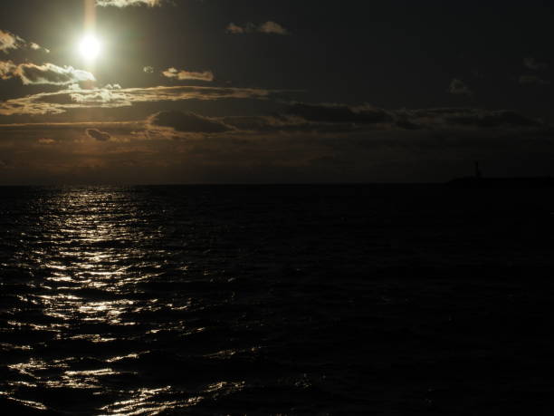 istock Dramatic sunset over Pacific ocean in winter with sunlight reflecting on water 1282962094