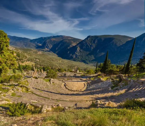 Photo of The ancient theater in the Archeological site of Delphi, Greece, a sacred precinct in ancient times that served as the seat of Pythia, the major oracle who was consulted about important decisions throughout the ancient classical world.