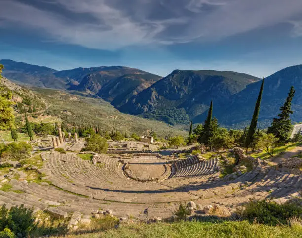 Photo of The ancient theater in the Archeological site of Delphi, Greece, a sacred precinct in ancient times that served as the seat of Pythia, the major oracle who was consulted about important decisions throughout the ancient classical world.