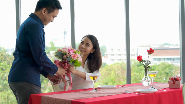istock Romantic couple giving gift to lover at restaurant 1282964656