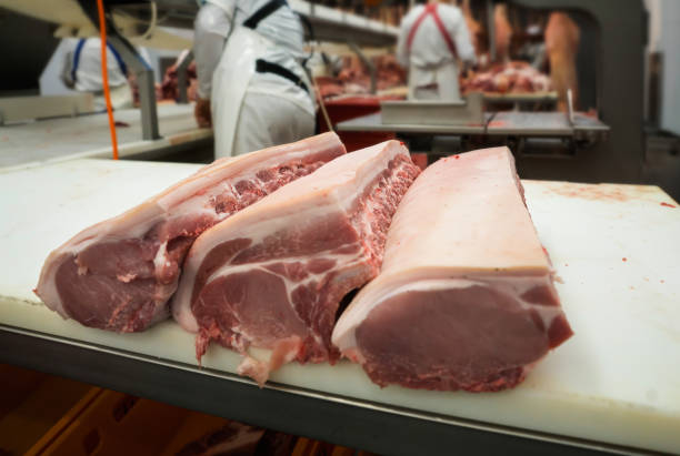 Cut pieces of pork are on the table stock photo