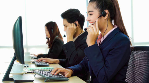 istock Business people wearing headset working in office 1282965884