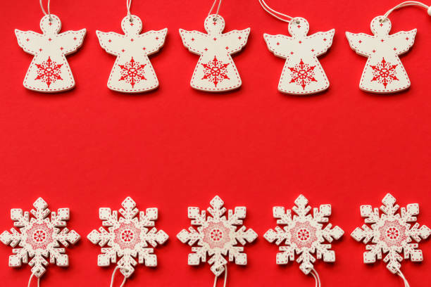 istock White and red wooden Christmas tree decorations on a red background with place for text 1282966180