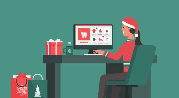 frau sitzt am schreibtisch und macht die bestellung auf einem computerbildschirm in seinem büro an den weihnachtsfeiertagen - shopping christmas women retail stock-grafiken, -clipart, -cartoons und -symbole