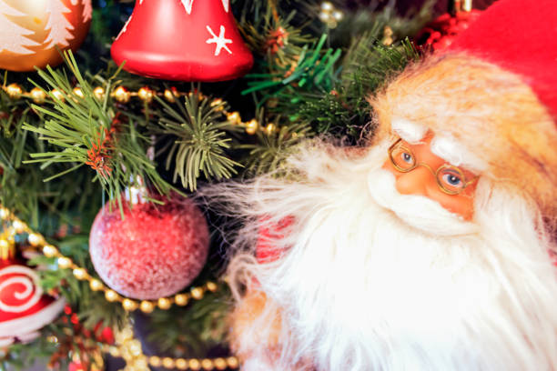 istock Toy Santa Claus is next to decorated Christmas tree. 1282968328